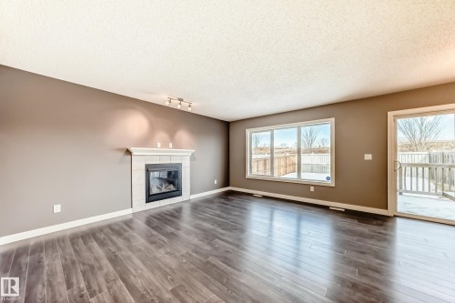 3520 49 Avenue, Beaumont, AB - Indoor Photo Showing Living Room With Fireplace