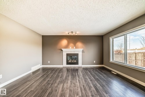 3520 49 Avenue, Beaumont, AB - Indoor Photo Showing Living Room With Fireplace