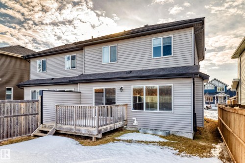 Snow covered rear of property featuring a deck - 3520 49 Avenue, Beaumont, AB - Outdoor With Deck Patio Veranda With Exterior