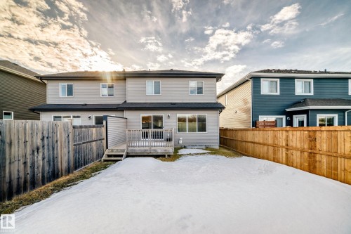 Rear view of house with a fenced backyard and a wooden deck - 3520 49 Avenue, Beaumont, AB - Outdoor With Deck Patio Veranda