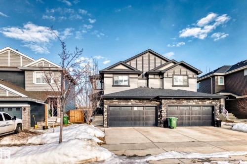Craftsman house with concrete driveway, stone siding, and roof with shingles - 3520 49 Avenue, Beaumont, AB - Outdoor With Facade