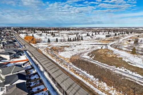 Snowy aerial view with a residential view - 3520 49 Avenue, Beaumont, AB - Outdoor With View