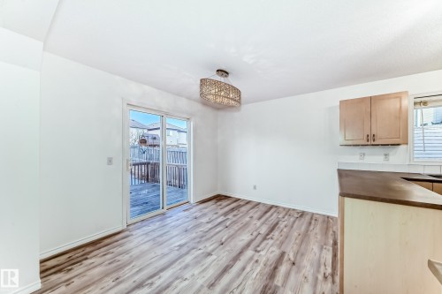 Unfurnished dining area with light wood finished floors and baseboards - 4604 202 Street, Edmonton, AB - Indoor Photo Showing Kitchen