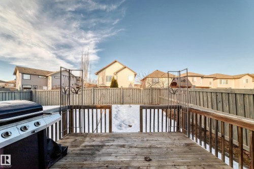 Deck with a residential view, a grill, and a fenced backyard - 4604 202 Street, Edmonton, AB - Outdoor With Exterior