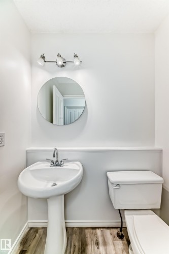 Bathroom featuring toilet and light wood-style floors - 4604 202 Street, Edmonton, AB - Indoor Photo Showing Bathroom