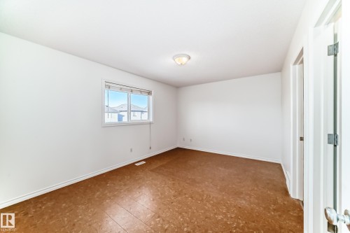 Unfurnished bedroom with baseboards and tile patterned floors - 4604 202 Street, Edmonton, AB - Indoor Photo Showing Other Room