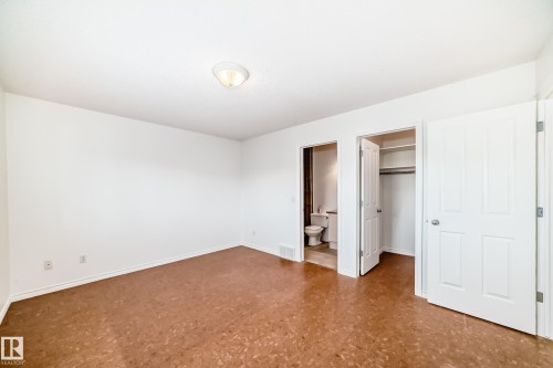 Unfurnished bedroom featuring a walk in closet, tile patterned floors, and ensuite bathroom - 4604 202 Street, Edmonton, AB - Indoor Photo Showing Other Room