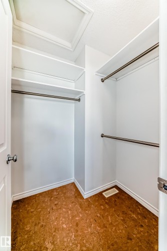 Walk in closet featuring dark flooring - 4604 202 Street, Edmonton, AB - Indoor Photo Showing Other Room