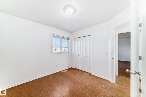 Unfurnished bedroom with baseboards and a closet - 4604 202 Street, Edmonton, AB - Indoor Photo Showing Other Room