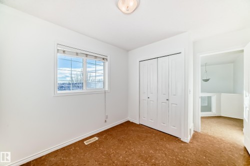 Unfurnished bedroom with a closet and baseboards - 4604 202 Street, Edmonton, AB - Indoor Photo Showing Other Room