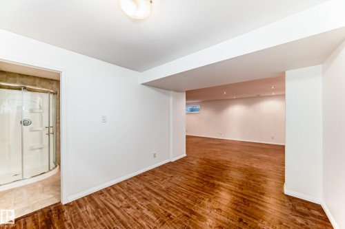 Finished below grade area featuring wood finished floors - 4604 202 Street, Edmonton, AB - Indoor Photo Showing Other Room