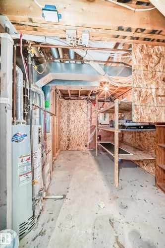 Unfinished below grade area featuring water heater and electric panel - 4604 202 Street, Edmonton, AB - Indoor Photo Showing Basement