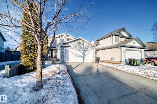 View of front of home with concrete driveway and an attached garage - 4604 202 Street, Edmonton, AB - Outdoor With Facade