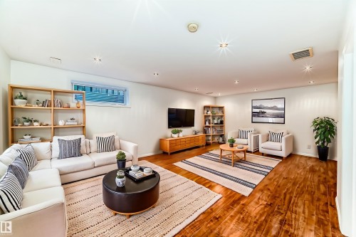 Living room featuring wood finished floors and recessed lighting - 4604 202 Street, Edmonton, AB - Indoor Photo Showing Living Room