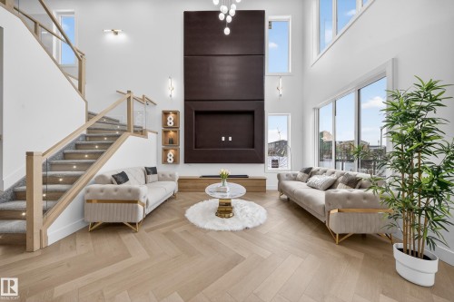 Living room with stairway, parquet floors, and a towering ceiling - 132 29 Street, Edmonton, AB - Indoor Photo Showing Living Room