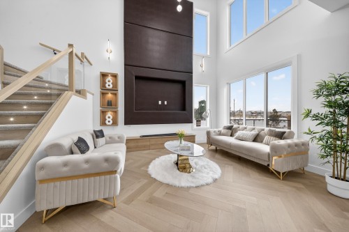 Living room with parquet floors, a high ceiling, and stairs - 132 29 Street, Edmonton, AB - Indoor Photo Showing Living Room