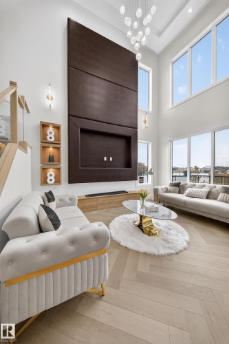 Living room with parquet flooring, a high ceiling, and a chandelier - 132 29 Street, Edmonton, AB - Indoor Photo Showing Living Room