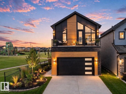 Contemporary exterior featuring dark siding and wood-finish accents - 132 29 Street, Edmonton, AB - Outdoor