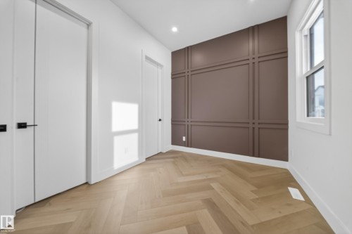 Unfurnished bedroom featuring a decorative wall, parquet floors, and recessed lighting - 132 29 Street, Edmonton, AB - Indoor Photo Showing Other Room