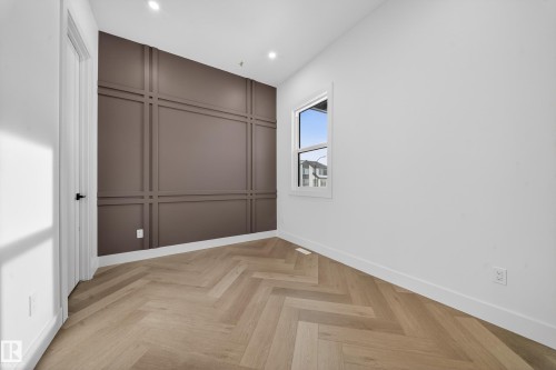 Unfurnished bedroom featuring a decorative wall, parquet flooring, recessed lighting, and a closet - 132 29 Street, Edmonton, AB - Indoor Photo Showing Other Room