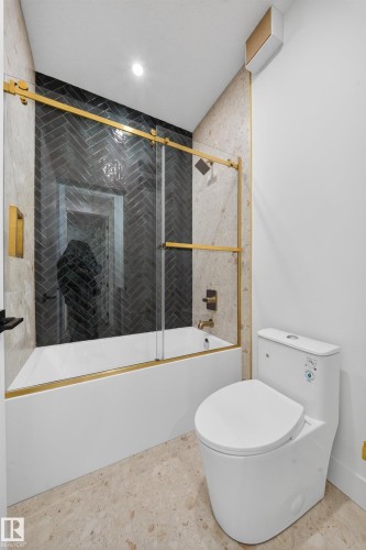 Bathroom featuring enclosed tub / shower combo and toilet - 132 29 Street, Edmonton, AB - Indoor Photo Showing Bathroom