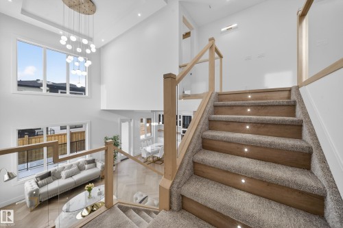 Stairs with a towering ceiling, parquet flooring, a chandelier, and recessed lighting - 132 29 Street, Edmonton, AB - Indoor Photo Showing Other Room