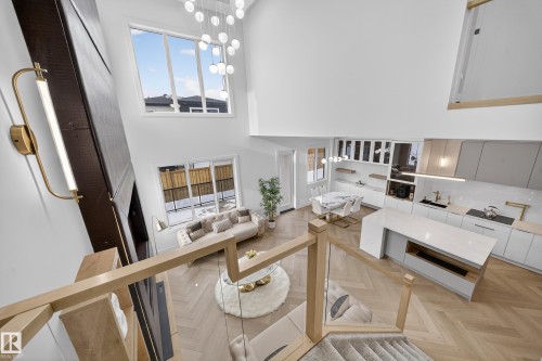 Living room with parquet floors, a towering ceiling, and a chandelier - 132 29 Street, Edmonton, AB - Indoor