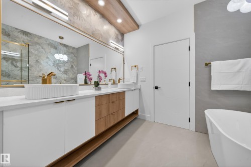 Bathroom with a soaking tub, vanity, recessed lighting, and concrete floors - 132 29 Street, Edmonton, AB - Indoor Photo Showing Bathroom