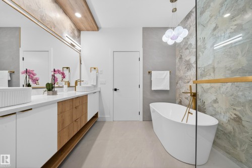 Bathroom featuring a freestanding tub, vanity, and concrete floors - 132 29 Street, Edmonton, AB - Indoor Photo Showing Bathroom