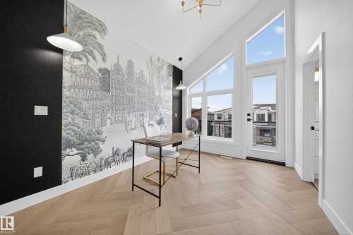 Office space featuring parquet flooring, high vaulted ceiling, and a chandelier - 132 29 Street, Edmonton, AB - Indoor