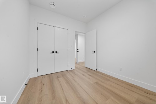Unfurnished bedroom featuring light wood finished floors and a closet - 132 29 Street, Edmonton, AB - Indoor Photo Showing Other Room