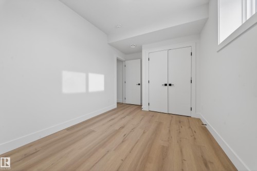 Unfurnished bedroom with light wood-style floors and a closet - 132 29 Street, Edmonton, AB - Indoor Photo Showing Other Room