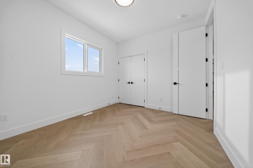 Unfurnished bedroom featuring parquet flooring and a closet - 132 29 Street, Edmonton, AB - Indoor Photo Showing Other Room