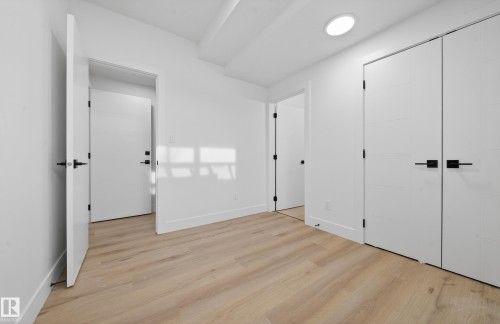 Unfurnished bedroom with light wood-style floors and a closet - 132 29 Street, Edmonton, AB - Indoor Photo Showing Other Room