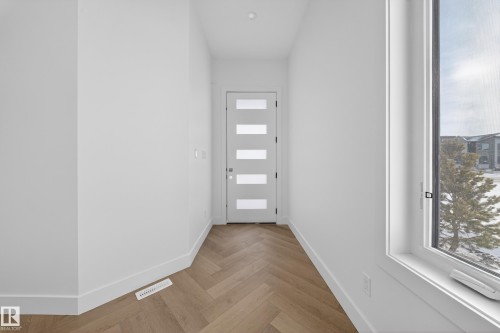 Entryway featuring parquet floors and plenty of natural light - 132 29 Street, Edmonton, AB - Indoor Photo Showing Other Room