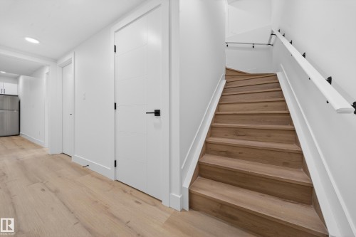 Stairway featuring wood finished floors and recessed lighting - 132 29 Street, Edmonton, AB - Indoor Photo Showing Other Room