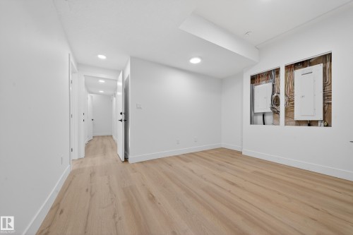 Empty room featuring electric panel, light wood finished floors, and recessed lighting - 132 29 Street, Edmonton, AB - Indoor Photo Showing Other Room