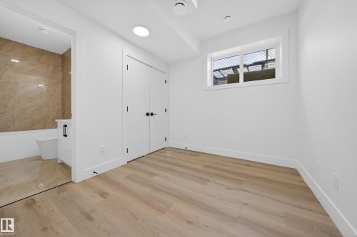 Unfurnished bedroom with light wood finished floors, ensuite bath, and a closet - 132 29 Street, Edmonton, AB - Indoor Photo Showing Other Room