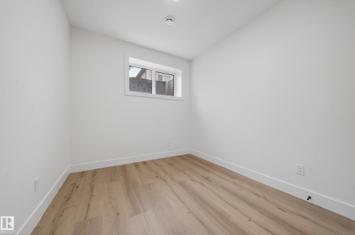 Empty room with light wood-style floors and lofted ceiling - 132 29 Street, Edmonton, AB - Indoor Photo Showing Other Room
