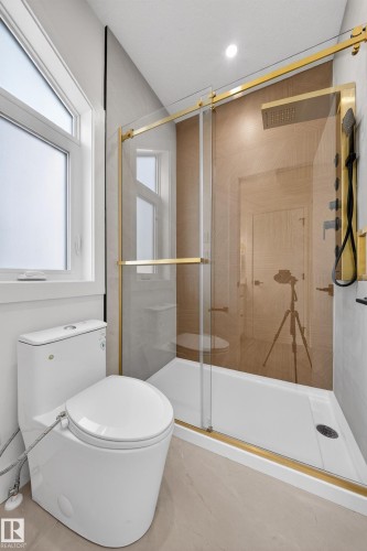 Bathroom featuring a stall shower and toilet - 132 29 Street, Edmonton, AB - Indoor Photo Showing Bathroom