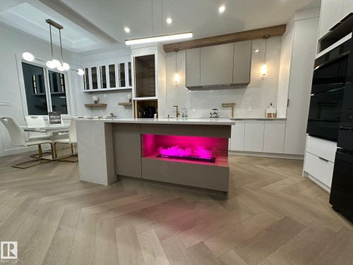 Two tone kitchen featuring two tone cabinets, parquet floors, open shelves, modern cabinets, and tasteful backsplash - 132 29 Street, Edmonton, AB - Indoor Photo Showing Kitchen