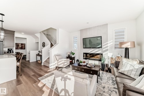 Living room with light wood-type flooring and recessed lighting - 3569 Erlanger Link, Edmonton, AB - Indoor Photo Showing Living Room With Fireplace