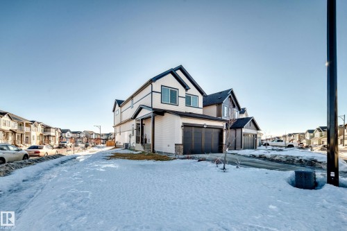View of front of property featuring a residential view and a garage - 3569 Erlanger Link, Edmonton, AB - Outdoor