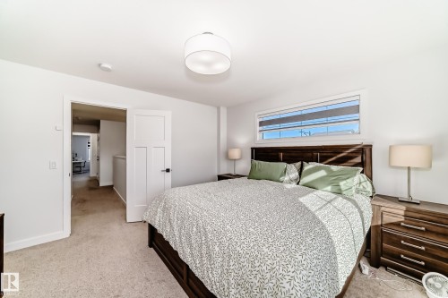 Bedroom with light carpet and baseboards - 3569 Erlanger Link, Edmonton, AB - Indoor Photo Showing Bedroom