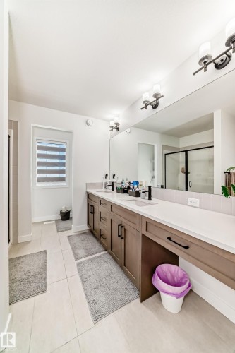 Bathroom with a stall shower, double vanity, and light tile patterned floors - 3569 Erlanger Link, Edmonton, AB - Indoor Photo Showing Other Room