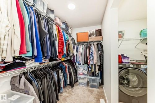 Walk in closet with washer / clothes dryer and light carpet - 3569 Erlanger Link, Edmonton, AB - Indoor With Storage