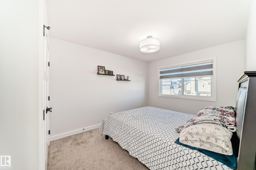 Bedroom featuring light colored carpet and baseboards - 3569 Erlanger Link, Edmonton, AB - Indoor Photo Showing Bedroom