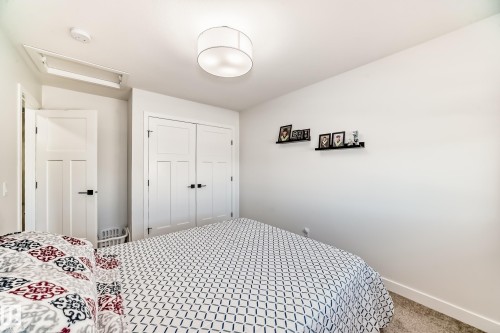 Carpeted bedroom with attic access and a closet - 3569 Erlanger Link, Edmonton, AB - Indoor Photo Showing Bedroom