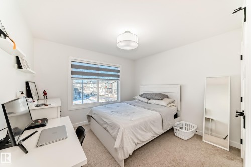 Bedroom with an office area and light colored carpet - 3569 Erlanger Link, Edmonton, AB - Indoor Photo Showing Bedroom