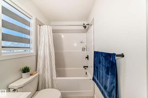 Bathroom with toilet and shower / bathtub combination with curtain - 3569 Erlanger Link, Edmonton, AB - Indoor Photo Showing Bathroom